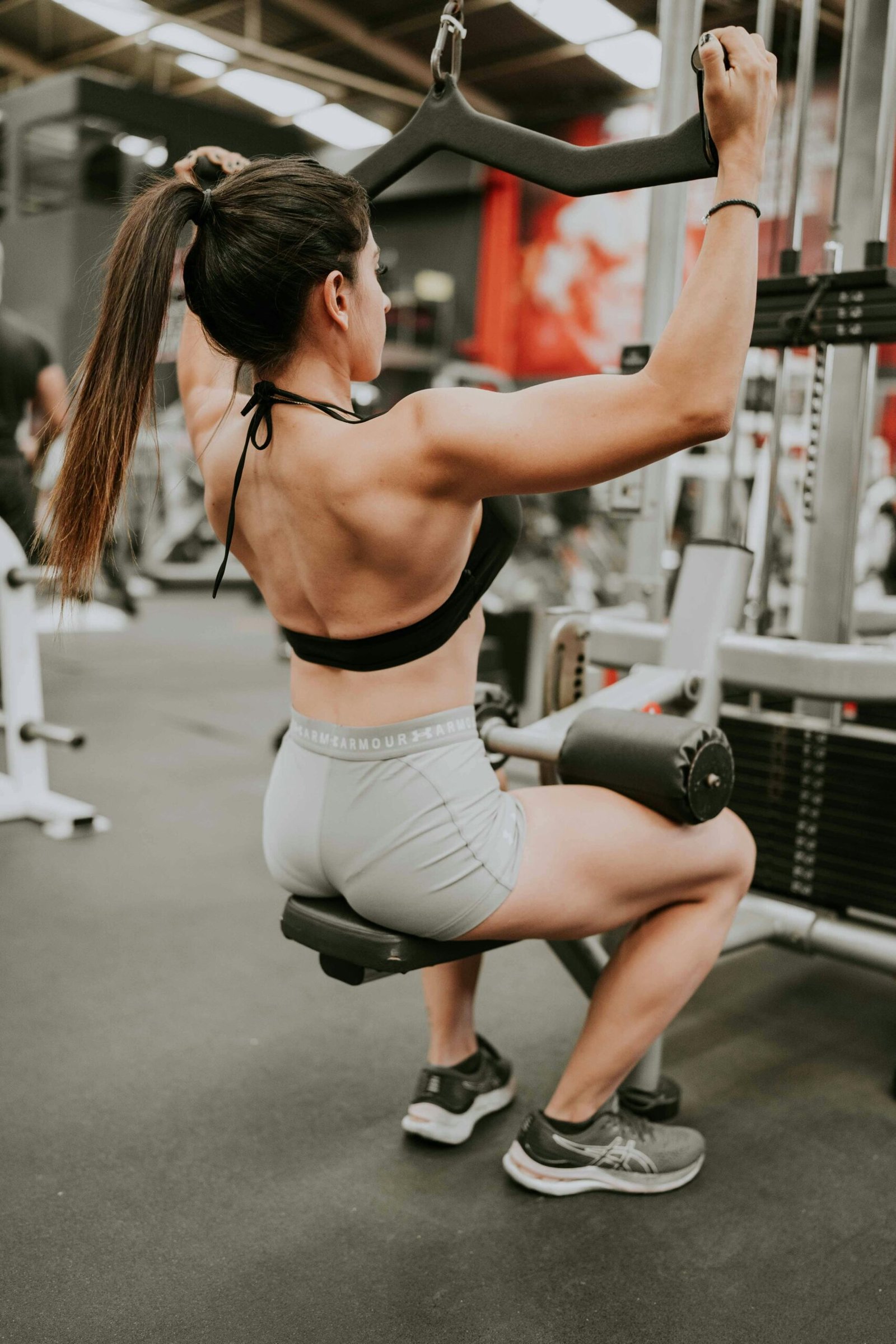 girl doing a back exercise called lat pulldowns